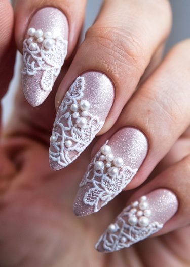 Elegant lace nail art featuring shimmering pastel pink with 3D embellishments and pearlescent beads.