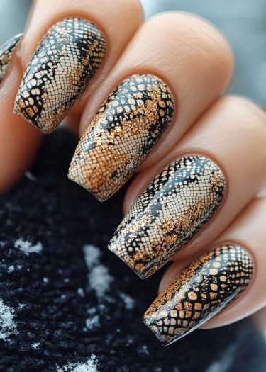 Elegant black and gold nail art features intricate reptilian designs and geometric patterns.