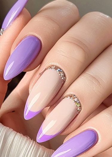 Elegant lavender and nude nail design with rhinestones for a luxurious manicure look.