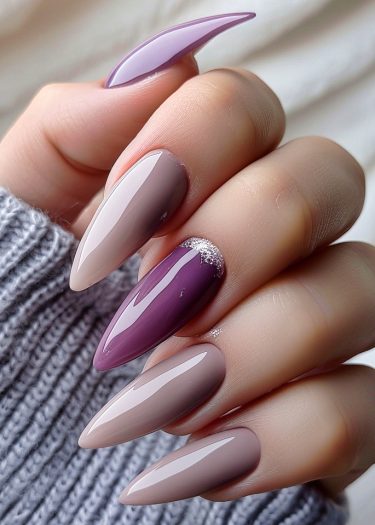 Elegant lilac and taupe nails with glitter, styled in almond shapes for sophisticated beauty.