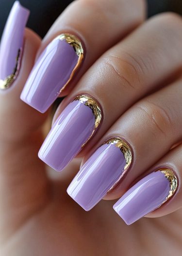 Elegant lavender manicure with gold accents, showcasing chic nail art for sophisticated style.