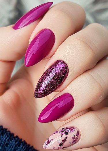 Stylish magenta stiletto nails with glitter accents and artistic floral designs elevate nail art.