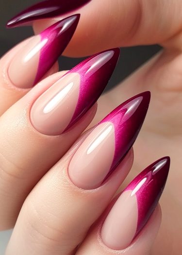 Elegant magenta stiletto nails featuring a stunning gradient French tip design.