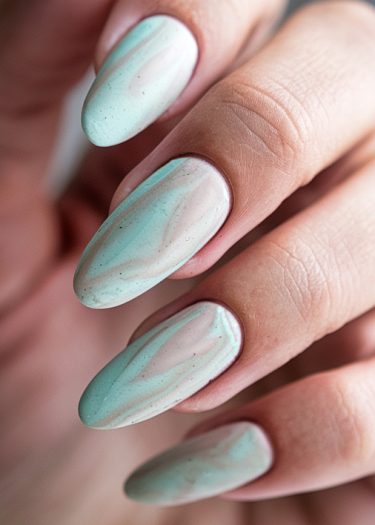 Elegant almond-shaped nails with pastel marbled design and glossy finish. Perfect nail art inspiration.