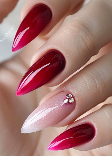 Elegant stiletto nails with gradient red polish and shimmering pink accent nail design.