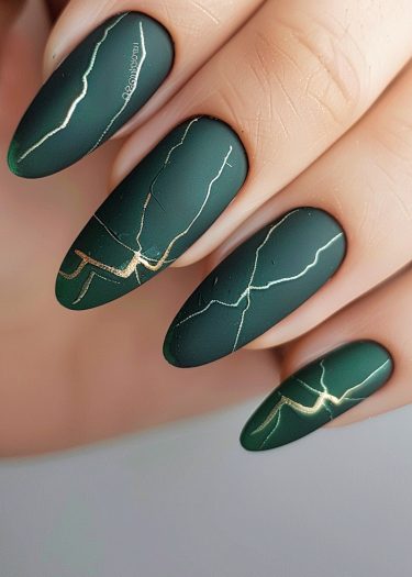 Elegant matte green nails with luxurious gold lines inspired by Kintsugi art.