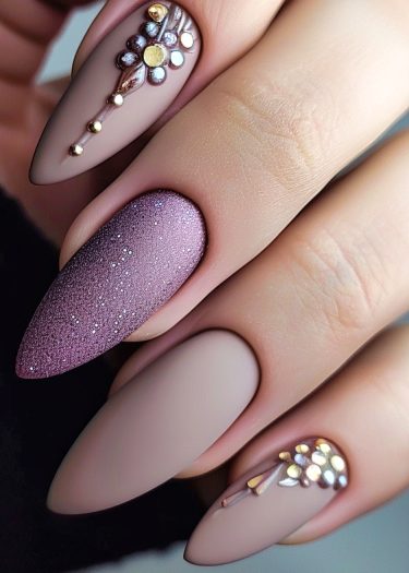 Elegant matte nail art with 3D gems and a shimmering accent for sophisticated style.