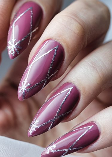 Elegant mauve stiletto nails with silver geometric designs and sparkly accents.