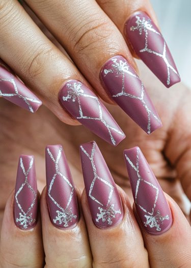 Elegant mauve stiletto nail art with silver diamond patterns and intricate embellishments.