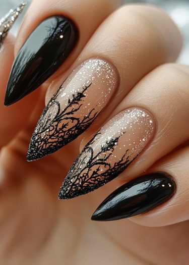 Stylish stiletto nails with glossy black and intricate black art make a bold fashion statement.