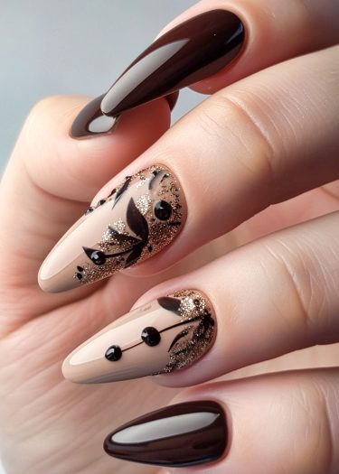 Elegant almond-shaped nail art design featuring dark brown polish, nude base, and gold glitter accents.