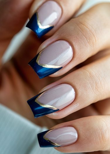 Elegant mauve nails with bold blue chevron tips and gold accent for modern nail art.