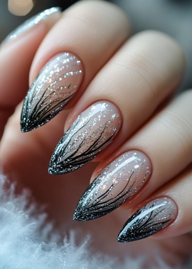 Elegant nude glitter nail art with black branch designs and ombre effects for a stunning look.