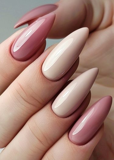 Elegant nude pink manicure with glossy almond-shaped nails in a beautiful gradient of earthy tones.