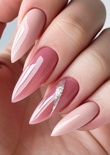 Elegant nude and pink ombré nails with glitter accent for a stylish manicure.