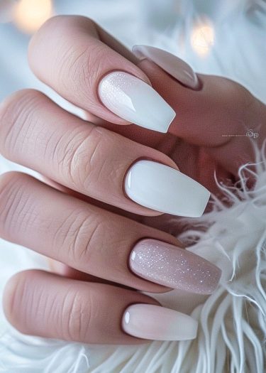 Sophisticated ombre nails with glitter accents on a luxurious background.