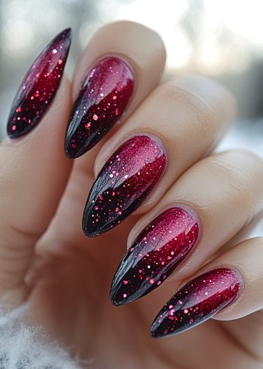 Stunning almond-shaped ombre nails with glitter, showcasing elegant red gradient and luxurious shine.