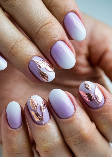 Elegant ombré nail art with rose gold metallic leaves and almond-shaped tips for a sophisticated look.