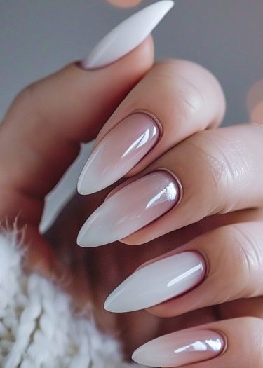 Elegant ombre nails with glossy finish showcase sophisticated nail art and feminine grooming.