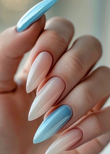 Elegant stiletto nails with a vibrant ombre gradient from pink to blue.