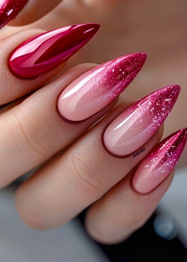 Elegant ombre stiletto nails with glitter, showcasing a glossy pink to red gradient.