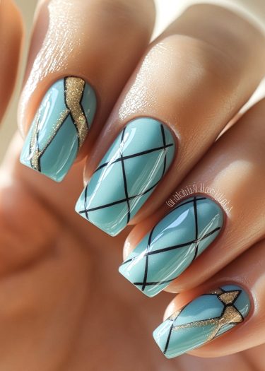 Elegant pastel blue nails with geometric black patterns and gold accents for a stylish look.