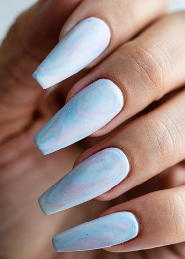 Elegant pastel coffin nails with marbled design in soft colors for a stylish look.