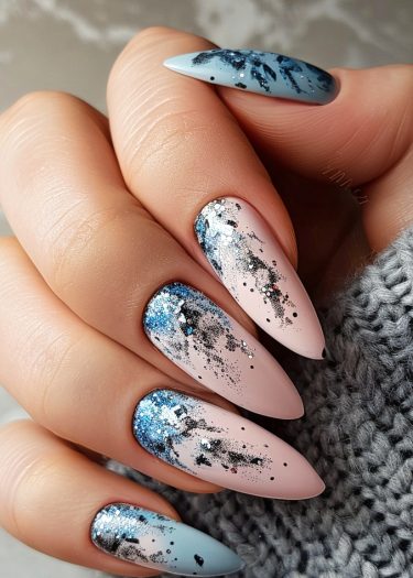 Stunning stiletto nail art with pastel gradient, black accents, and shimmering glitter.