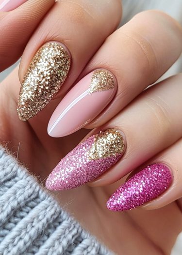 Elegant pink and gold manicure featuring intricate designs and shimmering glitter accents.