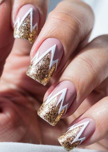 Elegant pink nails with gold glitter tips and white accents for a stylish manicure.