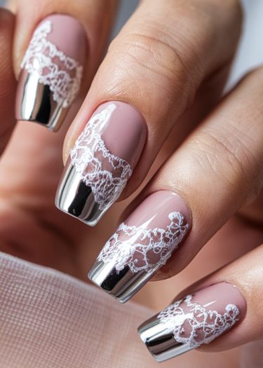 Elegant blush pink lace nails with metallic silver tips for a sophisticated manicure design.