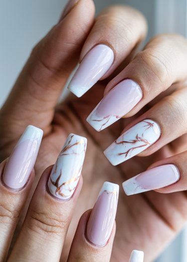 Elegant pink nail design with marble art and shimmering accents for a sophisticated look.