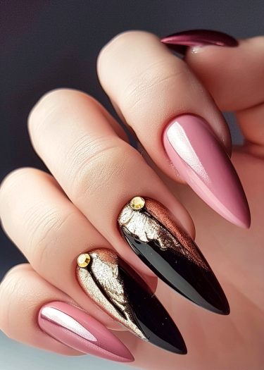 Sophisticated stiletto nails with glossy pink and luxurious black and gold designs.