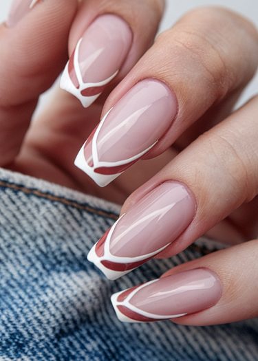 Elegant pink nail art featuring intricate white designs on beautifully manicured nails.