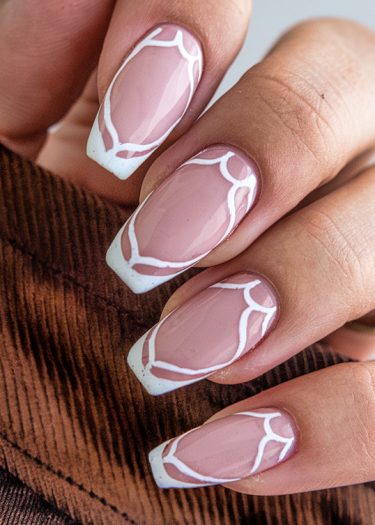 Stylish pink nail art with geometric design on square oval nails, showcasing elegance and modernity.