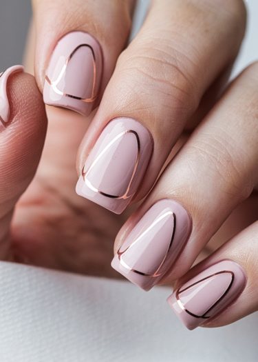 Chic pink nails with rose gold accents showcase elegant manicure design.