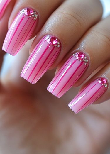 Elegant pink nail design with jewels and rhinestones for a luxurious manicure look.