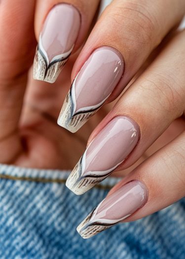 Elegant manicured nails with intricate black, white, and brown designs on a nude background.