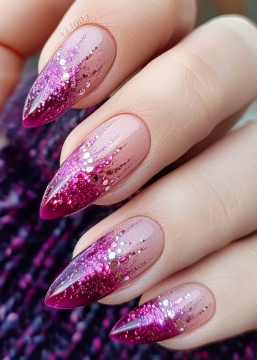 Elegant pink ombre nails with glitter, featuring long almond shapes and a chic design.