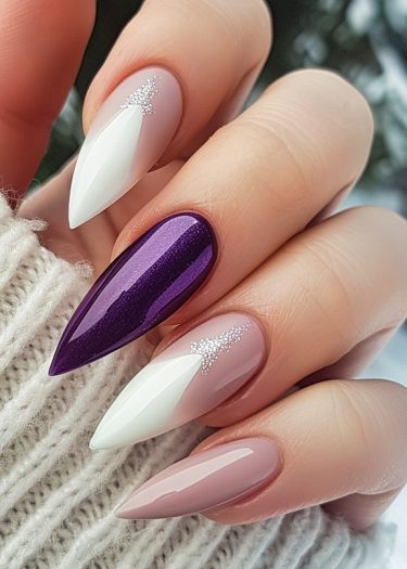 Elegant stiletto nail art featuring pink and purple designs on manicured nails against cozy fabric.