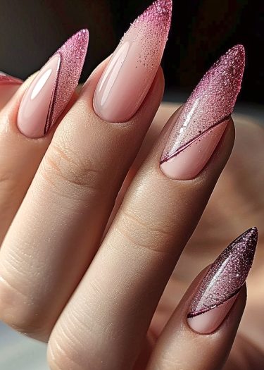 Sophisticated stiletto nails with pink ombre and glitter, showcasing elegant nail art design.