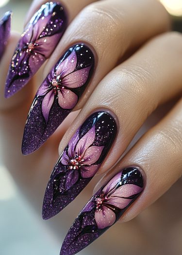 Stunning stiletto nails with purple floral design and glitter for elegant nail art lovers.