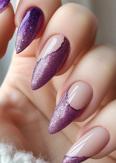 Almond-shaped purple glitter nails with a nude gradient for an elegant, sophisticated look.