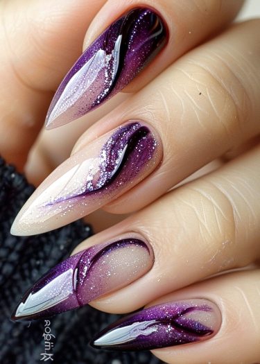 Stiletto nails with a stunning purple gradient and intricate marble patterns create a glamorous look.