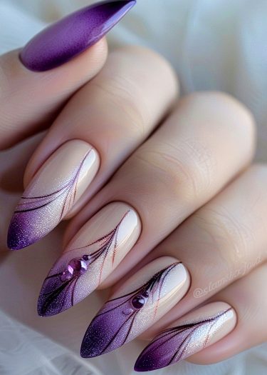 Elegant stiletto nails with purple gradient, intricate patterns, and sparkling rhinestones for a luxurious look.