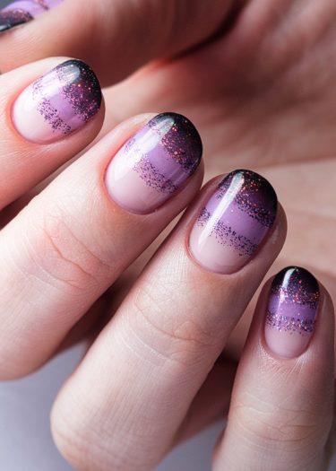 Elegant purple gradient nails with glitter, showcasing sophisticated nail art design and style.