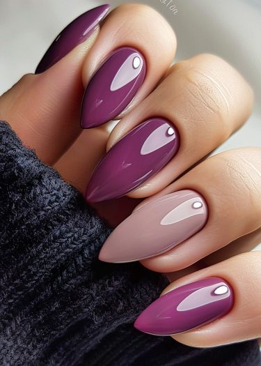 Elegant purple gradient nails showcase sophisticated nail art against a dark, cozy backdrop.