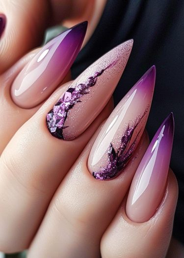 Elegant purple ombre stiletto nails with floral accents and glossy finish for stylish manicures.