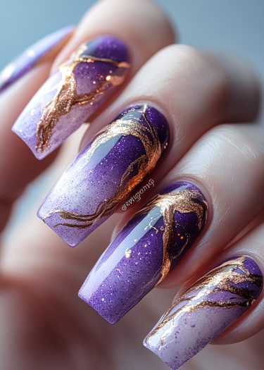 Elegant purple ombre nails with gold accents for a stylish and artistic look.