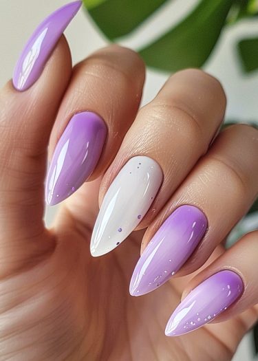 Elegant almond-shaped purple ombré nails with a playful white accent for a sophisticated look.